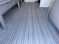 A 2012 Ford Econoline E-450 with a spacious interior and metal flooring designed for utility and transport purposes