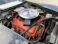 The image shows the engine compartment of a 1972 Chevrolet Corvette featuring a large chrome air cleaner red engine block and various hoses and components