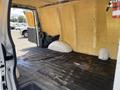 Interior of a 2009 Chevrolet Express cargo van showing bare walls and floor with insulation material and no visible cargo or equipment