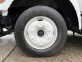 A close-up of a white wheel with a black tire labeled Arisun on a 2013 Ford F-650 showcasing its rim and lug nuts