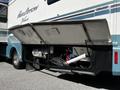A 2000 Ford Motorhome with open storage compartments revealing equipment and pipes inside