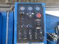 Control panel of a 1997 Genie S-65 4X4 featuring various gauges switches and buttons for machine operation and safety functions