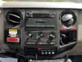 Dashboard controls of a 2009 Ford F-550 featuring climate control knobs radio display and various switches