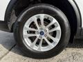 Close-up of a silver alloy wheel from a 2020 Ford Escape featuring a Continental tire with visible tread pattern and a Ford logo in the center cap