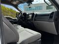 Interior view of a 2020 Ford F-350 Super Duty featuring a gray cloth seat and dashboard with controls and storage compartments
