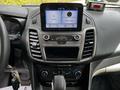 Interior dashboard of a 2019 Ford Transit Connect featuring a digital display touchscreen and various control buttons for audio and climate settings
