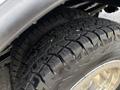 Close-up of two large, rugged tires on a vehicle showcasing deep treads designed for off-road traction and durability