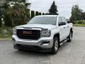 A 2016 GMC Sierra 1500 pickup truck in white with a chrome grille and accents parked on a driveway