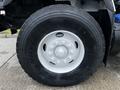 Close-up of a tire on a 2017 International WorkStar 7600 showing a Michelin brand tire with distinct tread patterns and a circular rim with multiple bolts