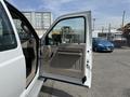 A 2008 Ford F-250 SD with an open driver side door showcasing the interior door panel and handle