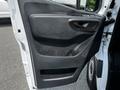 A close-up view of the door panel of a 2019 Mercedes-Benz Sprinter showing its black plastic design and door handle