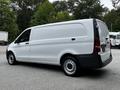 A 2020 Mercedes-Benz Metris cargo van with a white exterior and black accents viewed from the rear side