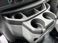 A gray cup holder area in a 2021 Ford E-450 with two cup holders and controls for temperature settings