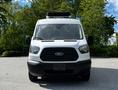 Front view of a 2015 Ford Transit van with a black grille and cooling unit on the roof