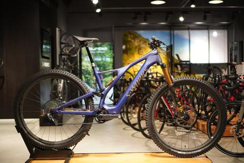 A 2024 Specialized Turbo Levo SL Comp Carbon electric mountain bike in a vibrant blue color with a lightweight carbon frame and thick off-road tires