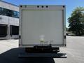 Rear view of a white 2021 Ford Econoline box truck with a solid back panel and visible taillights