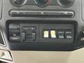 Control panel of a 2008 Ford F-550 with buttons for gain, output, and auxiliary power options