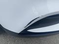 A white 2018 Buick Encore with a noticeable scratch on the front bumper