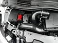Close-up of the engine compartment of a 2020 Mercedes-Benz Metris showing the air intake and battery with visible hoses and electrical components