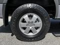 A close-up of a silver alloy wheel on a 2017 Mercedes-Benz Sprinter featuring an all-terrain tire with a rugged tread pattern