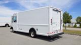 A white 2011 Ford Econoline cargo van with a large rear cargo area and back doors parked in a lot