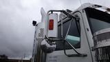 A 2019 Western Star Trucks 4900 with a chrome side mirror and polished exhaust stack