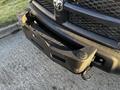 Close-up of the front bumper of a 2014 RAM 5500 showing dirt and grime on a winch-mounted bumper with tow hooks visible