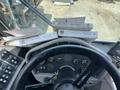 The interior view of a 2015 Global Street Sweeper showing the steering wheel and control panel with operational buttons and manuals on the dashboard