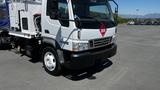 A 2006 Ford LCF 550 truck with a white exterior and a visible hazard symbol on the front, featured alongside a large wheel and part of the vehicle's body