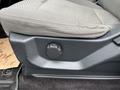 Close-up of the adjustable seat lever on the side of a gray cloth truck seat in a 2016 Ford F-150