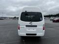 A white 2002 Nissan Van with a rear view showing the words CARAVAN and a wheelchair accessibility symbol