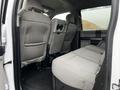 Interior view of a 2020 Ford F-350 SD showing the rear seating area with gray cloth upholstery and a spacious cabin design