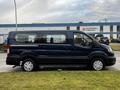 A 2020 Ford Transit van in dark blue with a sliding side door and large windows, featuring a spacious interior and silver wheel covers