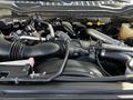 A 2018 Ford F-550 engine showing various components including the intake manifold, hoses, and a large air filter