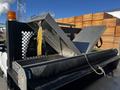 A 2011 Ford F-350 SD with an open metal toolbox in the truck bed featuring a black cover and a yellow strap securing the contents