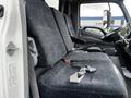 Interior view of a 2019 Hino 195 truck featuring front seats with grey fabric upholstery and seatbelts visible on the left side