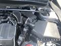The image shows the engine compartment of a 2017 Acura TLX with various components including hoses wires and an air intake assembly