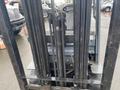 2011 Toyota 028FG15 forklift with vertical mast and chains visible in the foreground