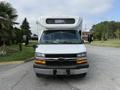 A white 2020 Chevrolet Express van with a black front grille and a sign displaying "SORRY" on the roof. The vehicle is parked and features side mirrors and headlights.