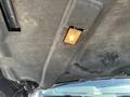 A 2011 RAM 1500's underhood light illuminating the engine compartment with a gray textured cover above