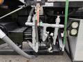 A close-up of the hydraulic system on a 2016 Peterbilt 348 featuring multiple valves and hoses connected to the chassis