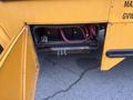A compartment of a yellow 2007 Freightliner B2 school bus showing an open door with visible hoses and connectors inside