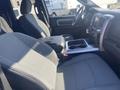 Interior view of a 2021 RAM 1500 showing front seats console and dashboard with a modern layout and gray upholstery