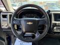 Steering wheel of a 2017 Chevrolet Silverado 1500 featuring a Chevrolet logo and control buttons on the wheel