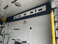 Interior view of a 2016 Chevrolet Express showing the wall control panel with various compartments and mounting fixtures