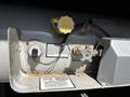 2000 Ford Motorhome gas line with fill valve vapor outlet and pressure regulator mounted on a metallic surface