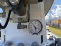 Close-up of a pressure gauge mounted on equipment, displaying readings with clear markings for pressure levels
