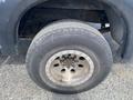 A close-up view of a tire on a 2007 Ford F-350 SD showcasing its tread pattern and rim design