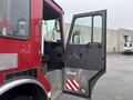 A 2006 E-One Typhoon fire truck with an open door revealing the driver’s seat and control panel inside