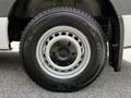 A close-up of a 2020 Mercedes-Benz Sprinter wheel with a black steel rim and a winter tire featuring a tread design for enhanced grip on snowy surfaces
